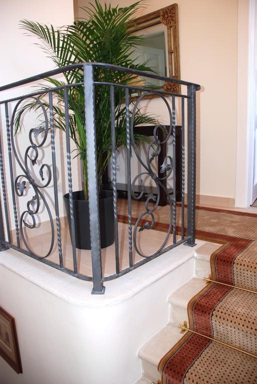 Wrought iron staircase with palm plant